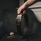 bruine leren riem zonder gaatjes met traploos verstelbaar systeem met klassieke achtergrond en accessoires
